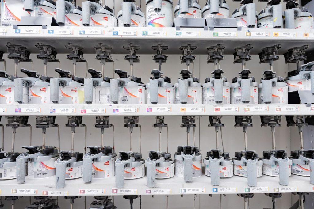 Organized industrial paint mixer station with multiple dispensers for accurate color mixing.